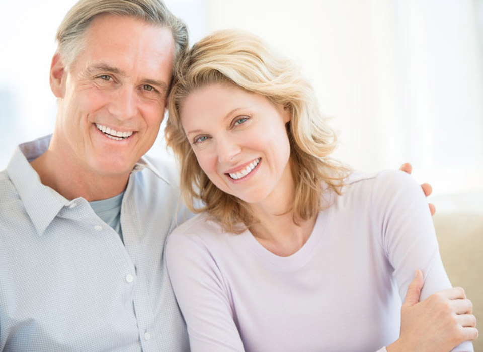 An older smiling couple